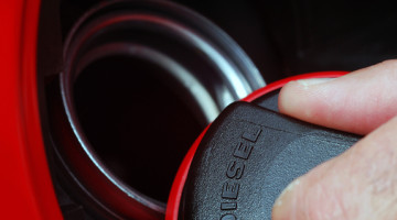 Extreme close-up of male fingers holding fuel cap